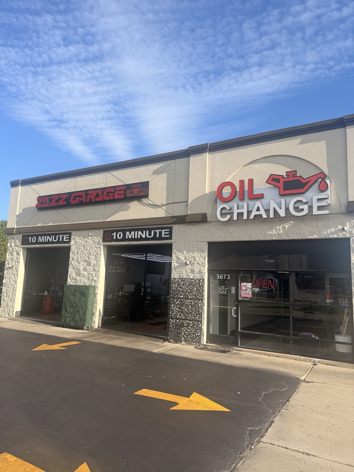 Zazz Garage and Oil Change in daylight, showing the open 10-minute service bays and entrance at 5673 15 Mile Road